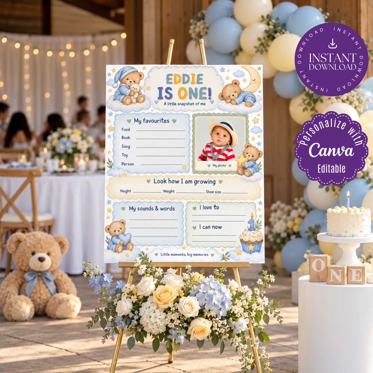 Boy's teddy bear first birthday milestone poster with a photo area and blue memory sections, on an easel beside pastel party decorations.