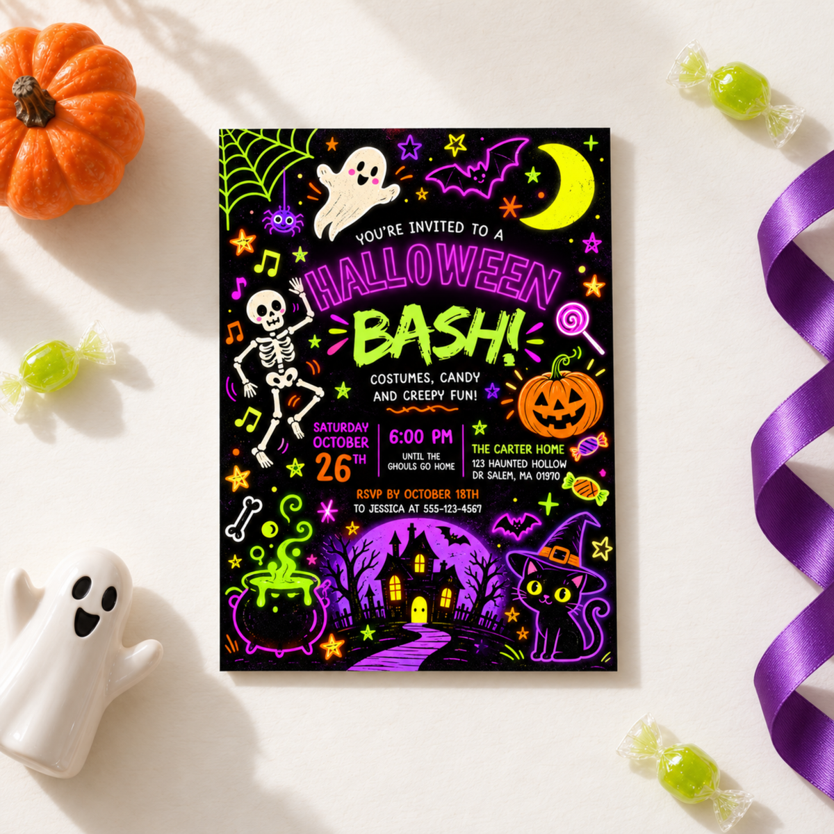 Halloween Bash invitation laid flat with pumpkins, candy and purple ribbon