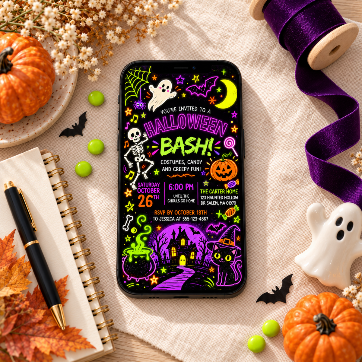 Halloween Bash invitation displayed on a phone beside candy and a ghost decoration