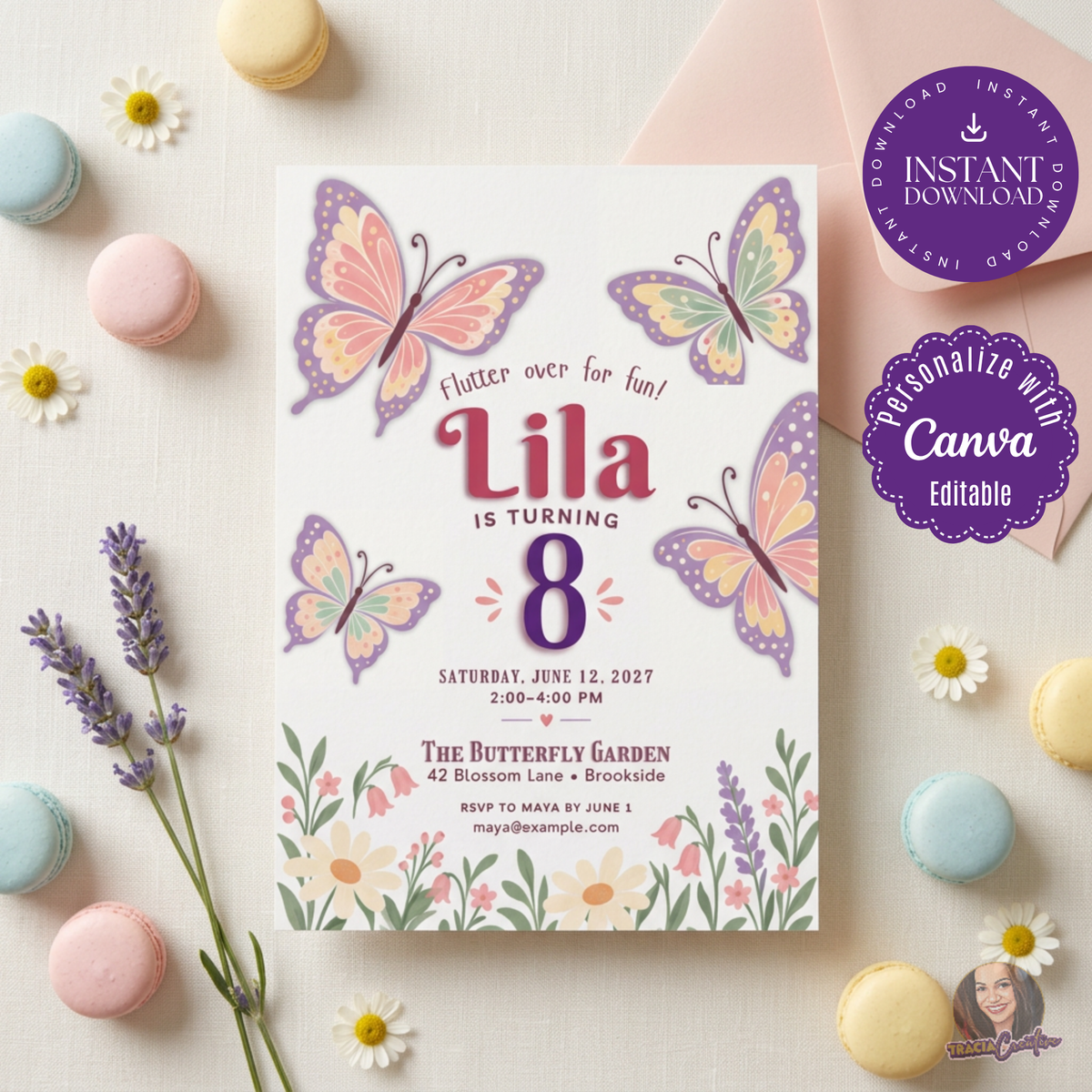 Butterfly garden birthday invitation with pink and lavender butterflies and wildflowers, laid flat among pastel macarons.