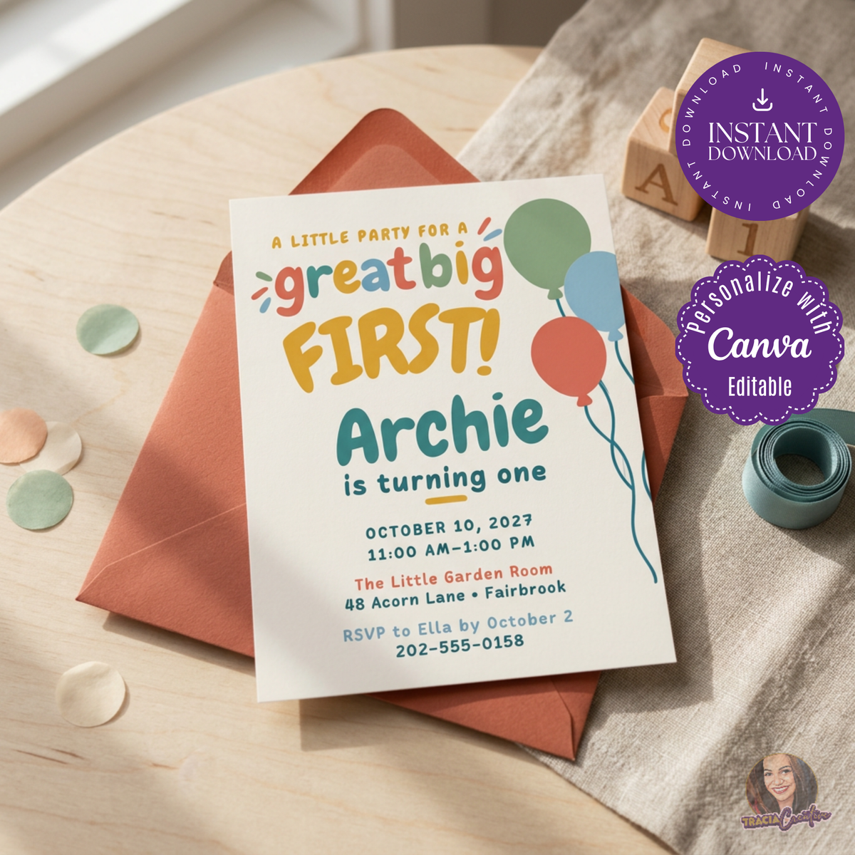 Colorful balloon first birthday invitation with playful Great Big First lettering, beside a terracotta envelope.