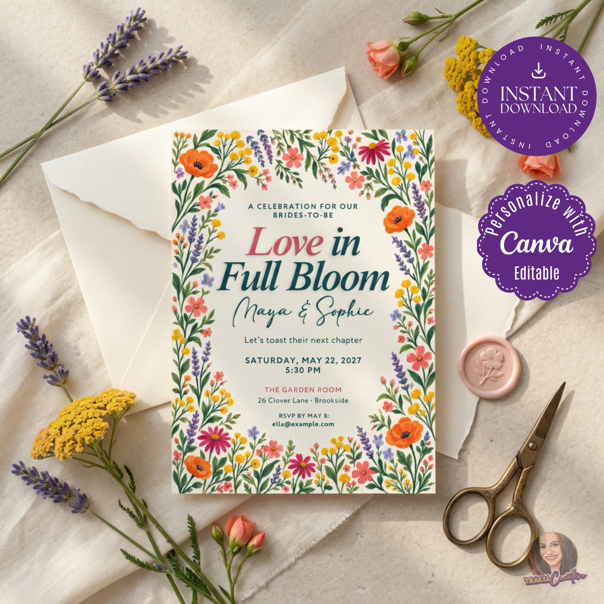 Love in Full Bloom shower invitation with a colorful wildflower border, styled with an ivory envelope and flowers.