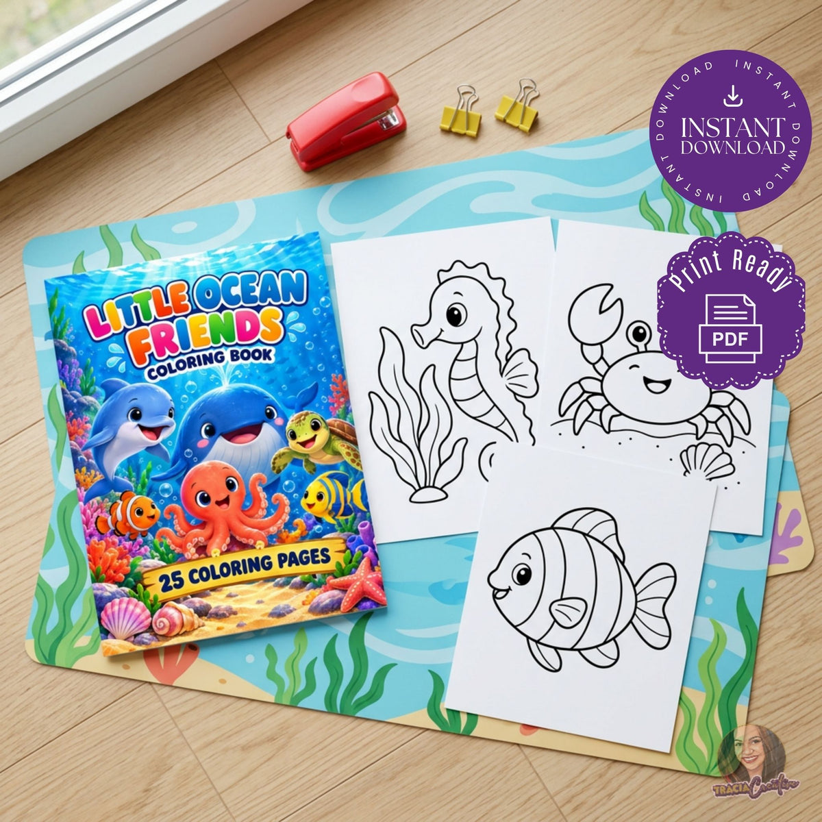 Little Ocean Friends cover with seahorse, crab and fish coloring sheets on a blue craft mat.