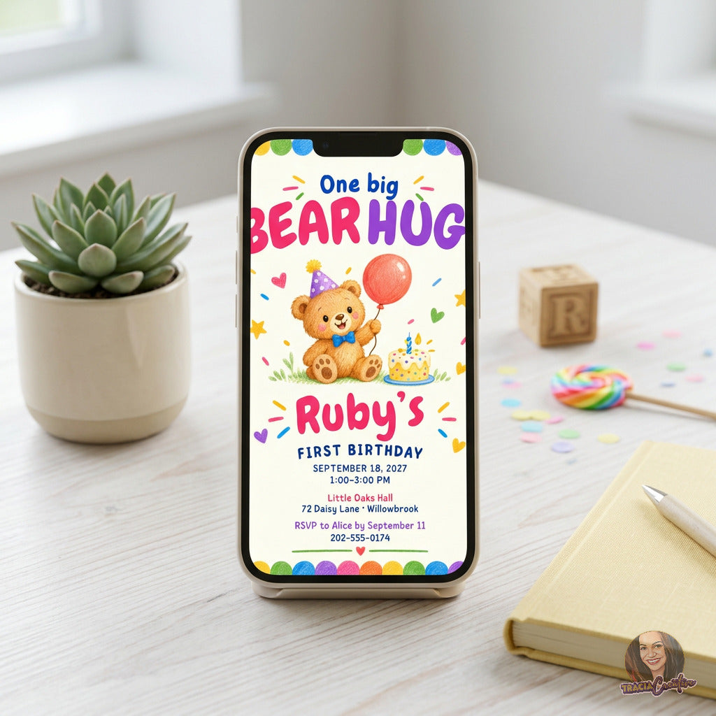 One Big Bear Hug first birthday invitation with a colorful teddy bear, balloon and confetti, displayed on a phone.